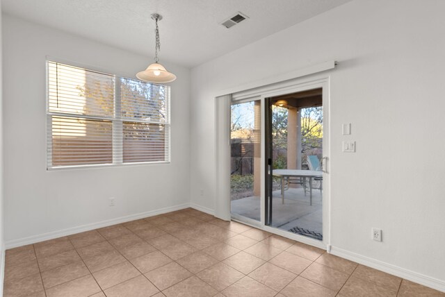 6923 Wrangell Loop NE, Rio Rancho, NM 87144 - unfurnished dining area featuring baseboards and light tile patterned floors