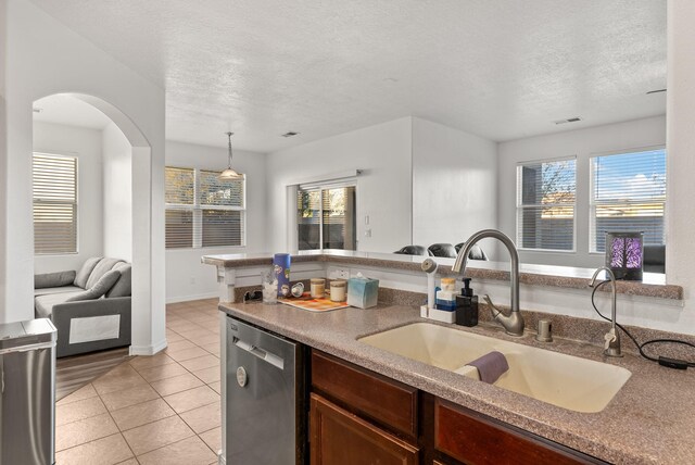 6923 Wrangell Loop NE, Rio Rancho, NM 87144 - kitchen with dishwasher, a sink, a textured ceiling, and healthy amount of natural light