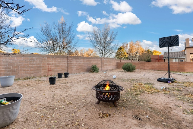 view of yard with a fire pit