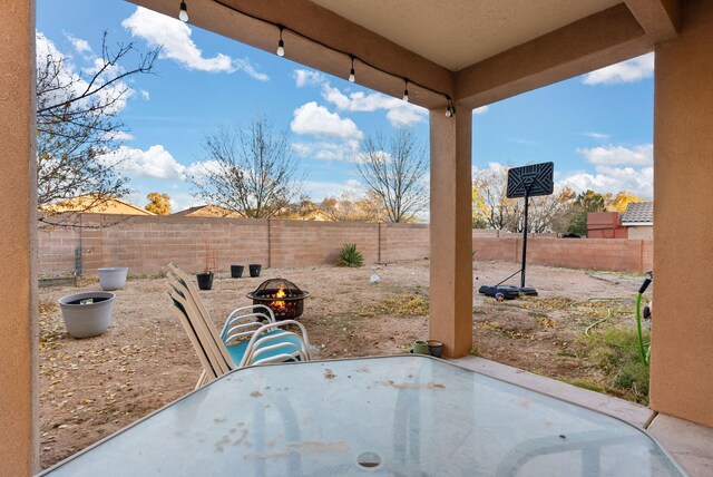 6923 Wrangell Loop NE, Rio Rancho, NM 87144 - fenced backyard featuring a patio area, a fire pit, and outdoor dining space
