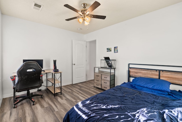 bedroom with hardwood / wood-style flooring and ceiling fan