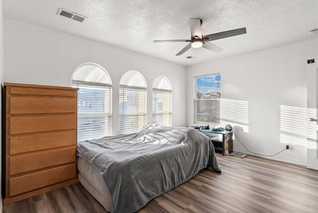 6923 Wrangell Loop NE, Rio Rancho, NM 87144 - bedroom featuring wood finished floors, a textured ceiling, and ceiling fan