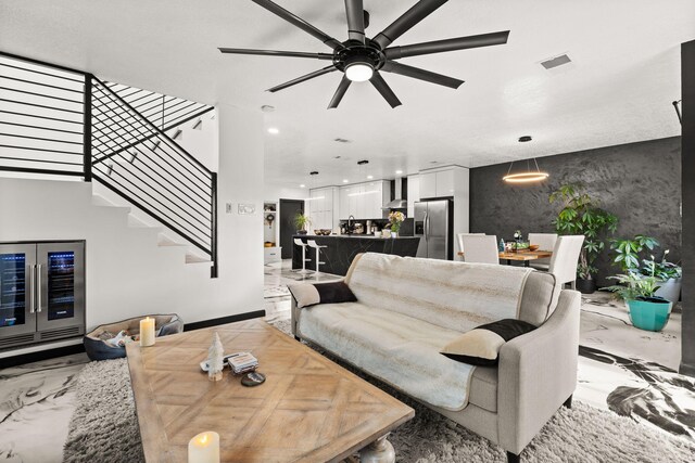 living room with ceiling fan and wine cooler