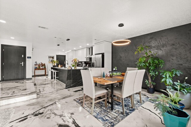 dining area featuring a textured ceiling