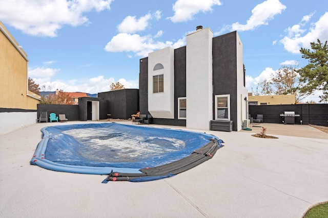 view of swimming pool featuring a grill and a patio area