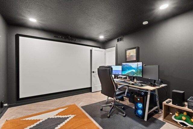 home office featuring a textured ceiling and light parquet flooring