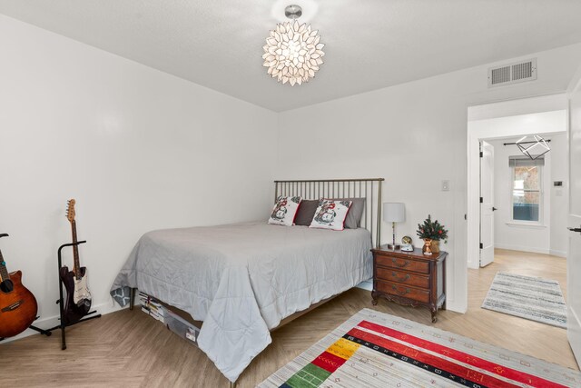 bedroom featuring a notable chandelier