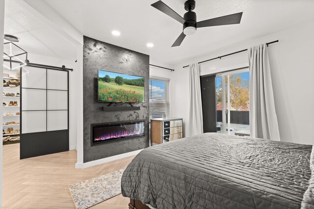 bedroom featuring a fireplace, access to outside, parquet floors, and ceiling fan