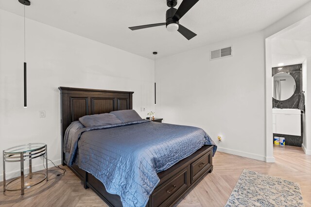 bedroom featuring connected bathroom, ceiling fan, and light parquet flooring