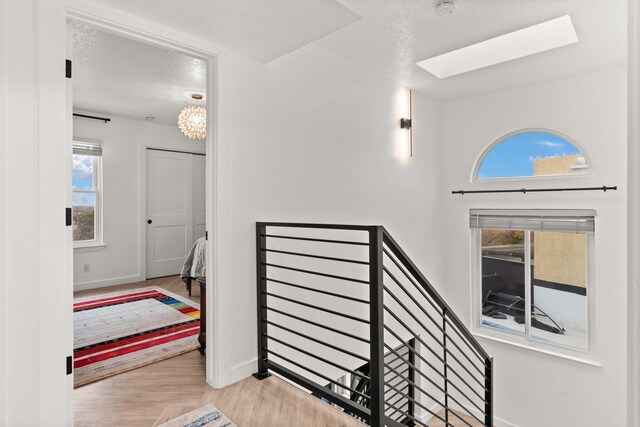 stairs featuring a textured ceiling and a healthy amount of sunlight