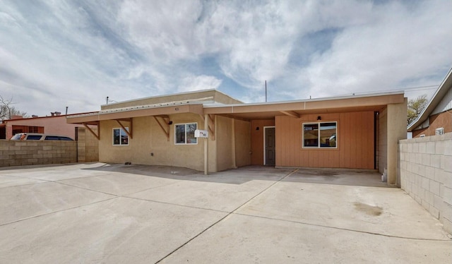 back of house with a carport