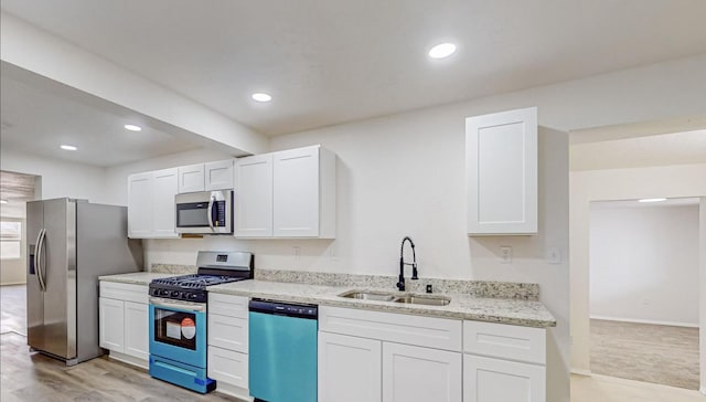 kitchen with sink, white cabinetry, and stainless steel appliances