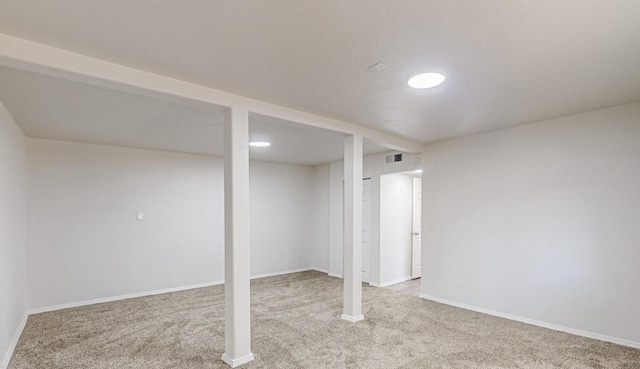 basement featuring light carpet