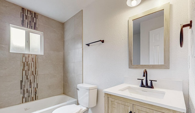 full bathroom with vanity, toilet, and tiled shower / bath