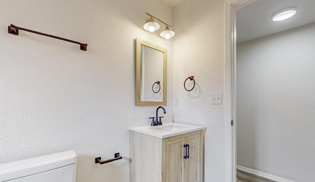 bathroom with vanity and toilet