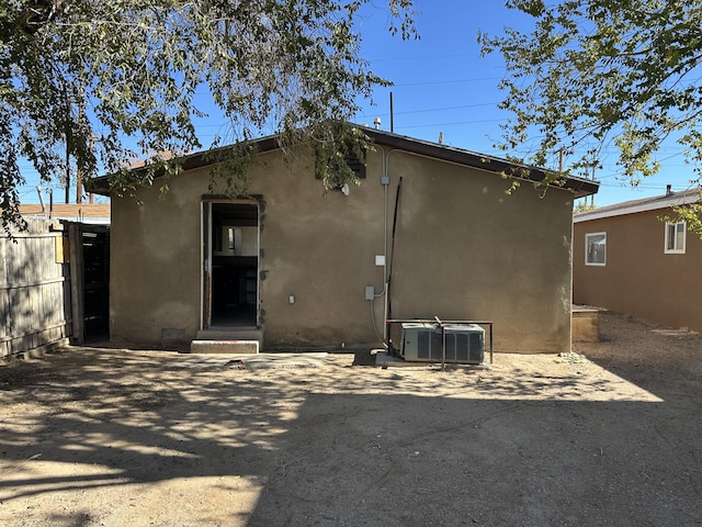 rear view of property with a patio area and central air condition unit