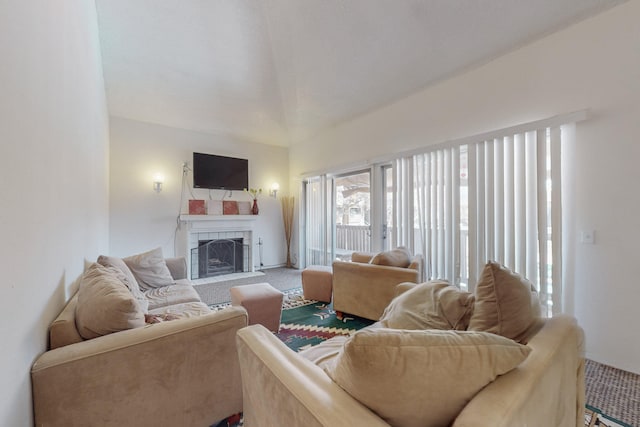 carpeted living room with a tile fireplace