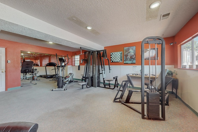 workout room featuring a textured ceiling