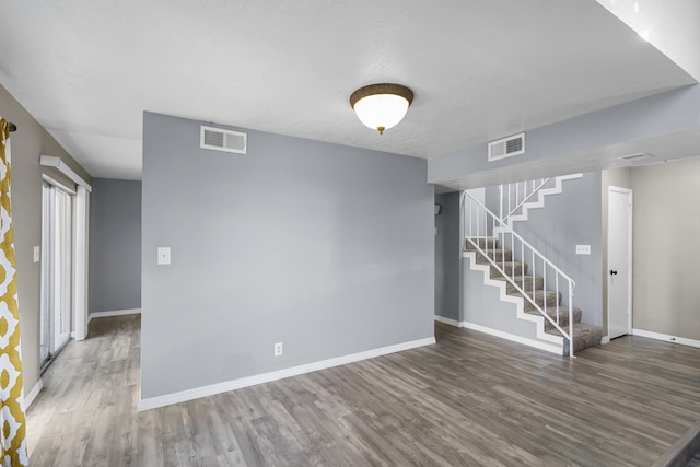 empty room with hardwood / wood-style flooring