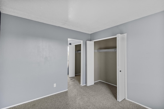 unfurnished bedroom featuring a closet and carpet flooring