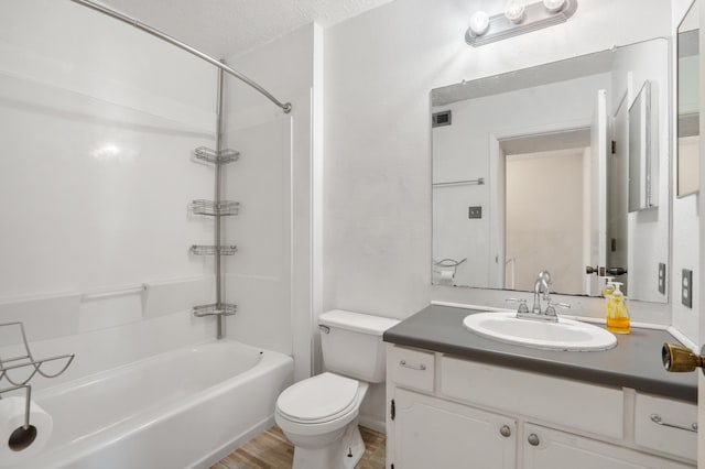 full bathroom with shower / bath combination, wood-type flooring, a textured ceiling, toilet, and vanity