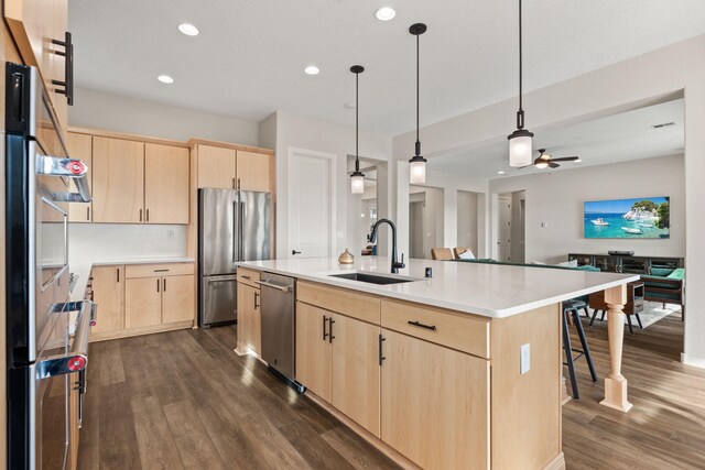 kitchen with sink, light brown cabinetry, a center island with sink, and appliances with stainless steel finishes