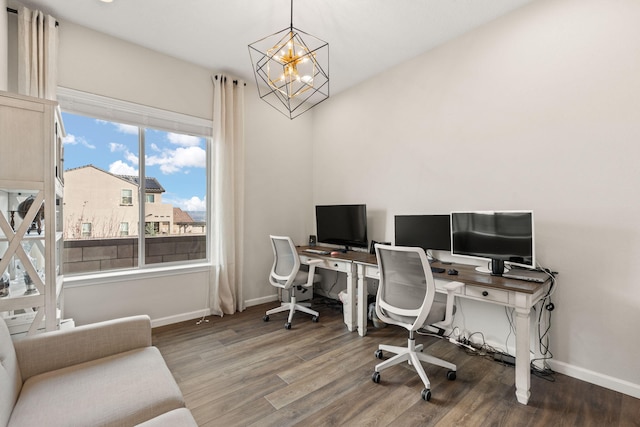 office with hardwood / wood-style floors and a chandelier