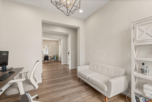 office area with hardwood / wood-style flooring and a notable chandelier