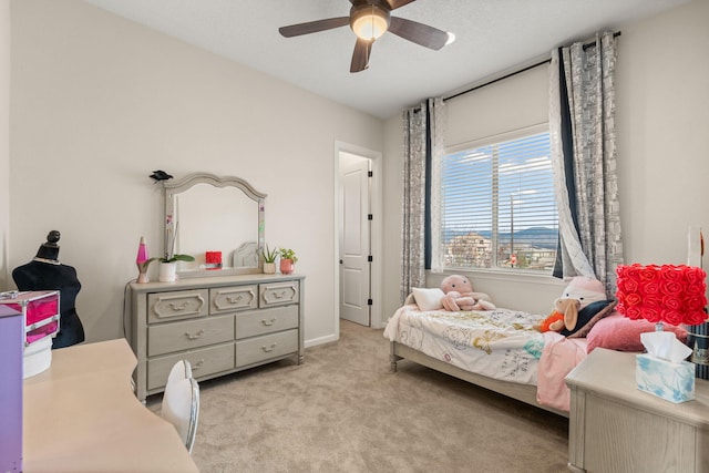 bedroom featuring light colored carpet and ceiling fan