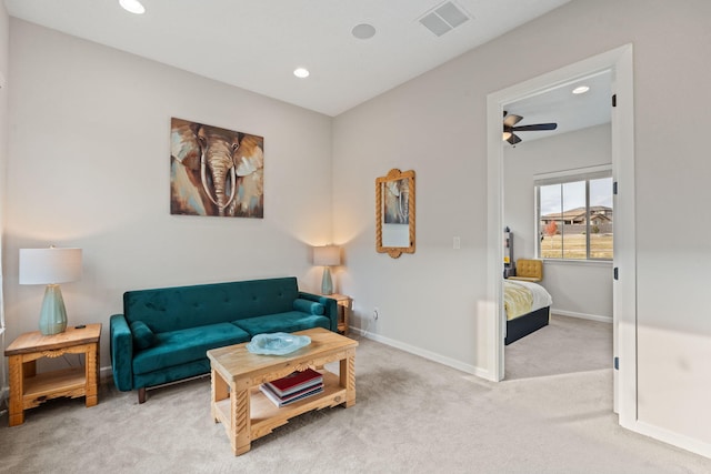 carpeted living room featuring ceiling fan