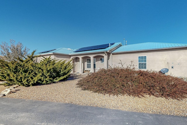 view of front of house featuring solar panels and a porch