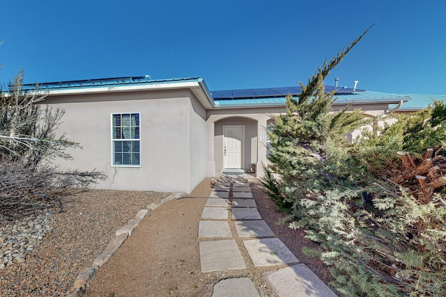 doorway to property featuring solar panels