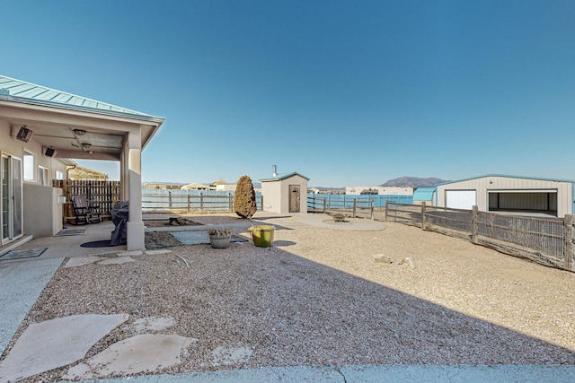 view of yard featuring a water view and an outdoor structure