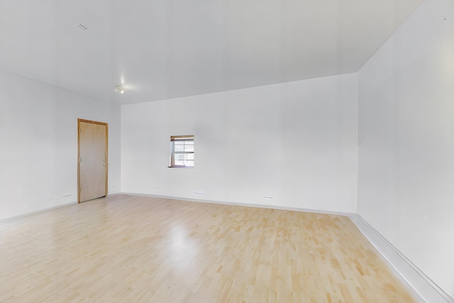 spare room with light hardwood / wood-style flooring