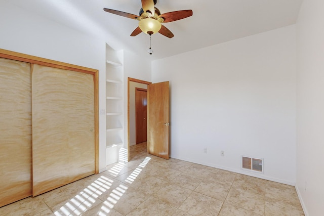 unfurnished bedroom featuring ceiling fan, light tile patterned floors, and a closet