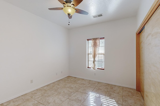 unfurnished room with ceiling fan and light tile patterned flooring