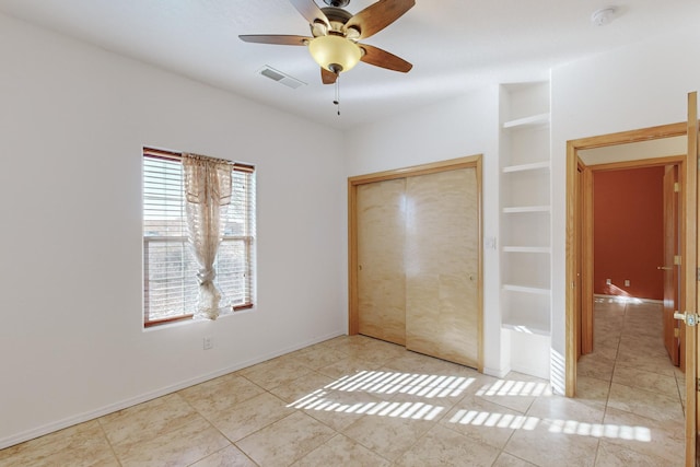 unfurnished bedroom with light tile patterned floors, a closet, and ceiling fan