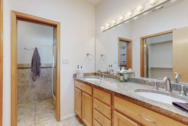 bathroom featuring tile patterned floors, vanity, and an enclosed shower