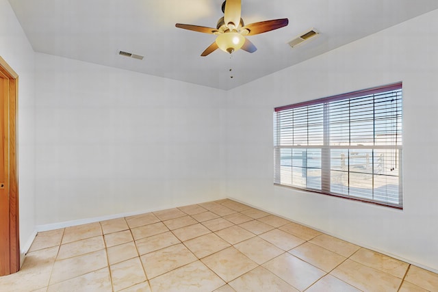 tiled empty room featuring ceiling fan