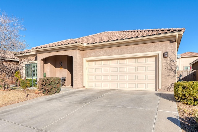 mediterranean / spanish-style home with a garage