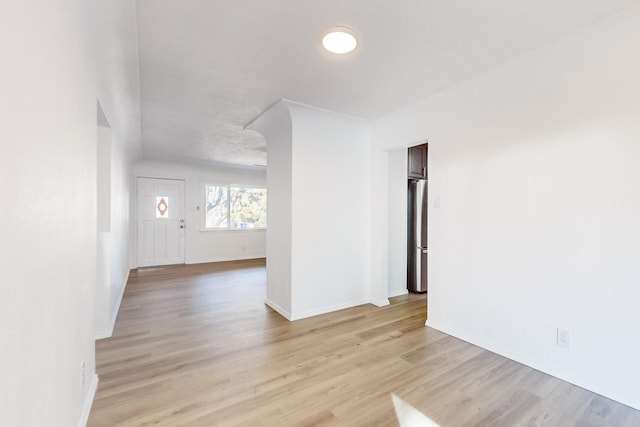 unfurnished room with light wood-type flooring