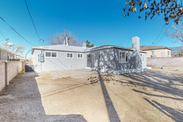 rear view of property with central AC unit