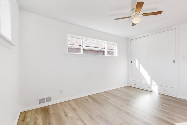 unfurnished room with ceiling fan and light hardwood / wood-style flooring