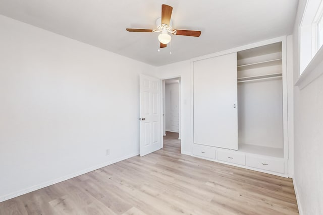 unfurnished bedroom with ceiling fan, a closet, and light wood-type flooring