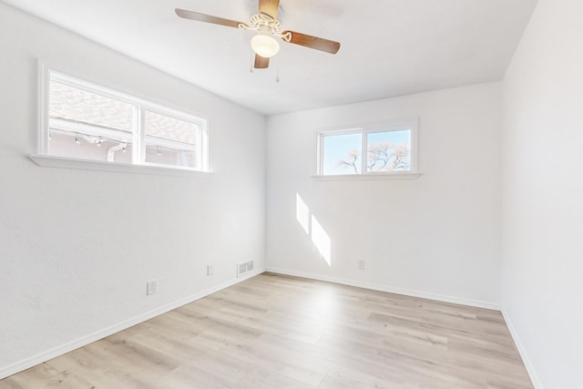 empty room featuring ceiling fan and light wood-type flooring