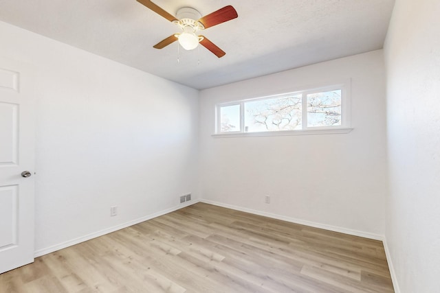 spare room featuring ceiling fan and light wood-type flooring