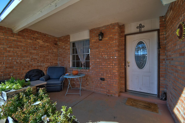 view of exterior entry with covered porch