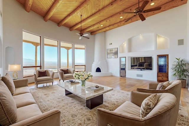 living room with high vaulted ceiling, visible vents, wood ceiling, light wood-style floors, and beamed ceiling