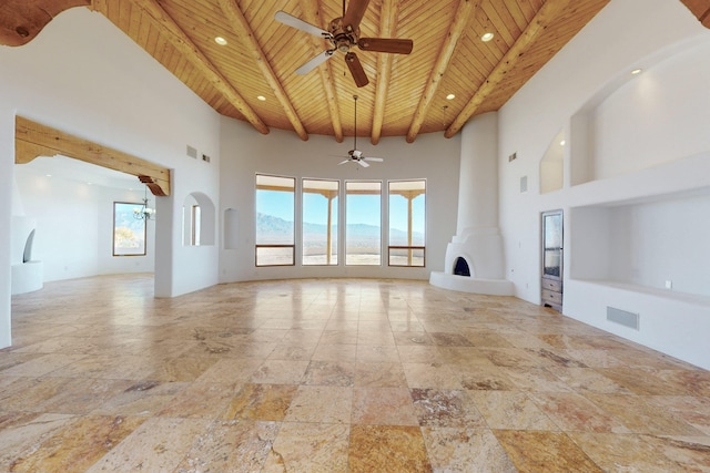 unfurnished living room with beamed ceiling, wooden ceiling, a towering ceiling, and visible vents