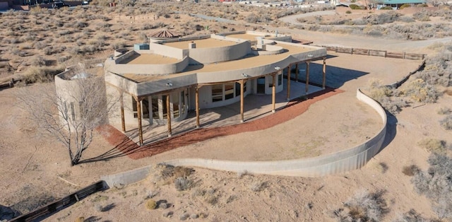 rear view of house featuring a patio area and a desert view